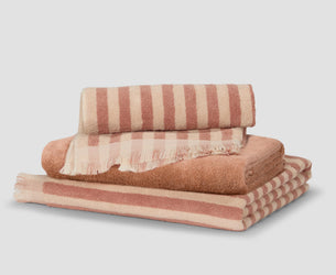 Stack of Sand Shell Pembroke Stripe and Fringe Edge Towels