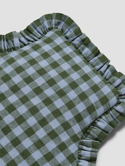 A close-up of a green and light blue gingham check fabric with a ruffled edge, shown on a light gray background.