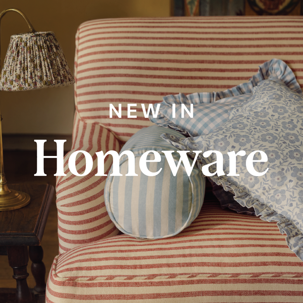 Striped armchair with cushions and a lamp, featuring 'New in Homeware' text.